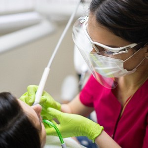 a dental hygienist cleaning a patient’s teeth