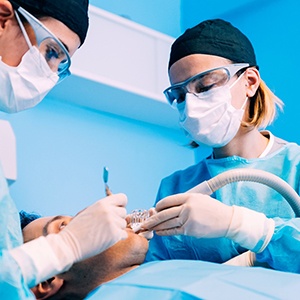 Oral surgeons performing surgery