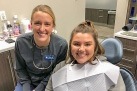 Team member and dental patient in exam room