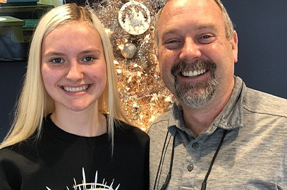 Dentist and teen dental patient smiling together