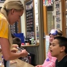 Dental team member talking to two kids