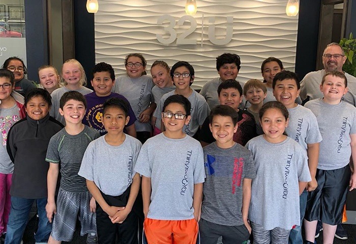 Dentist and group of kids smiling together