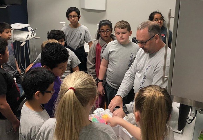 Dentist talking to kids about dentistry