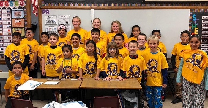 Kids and dental team members at event wearing matching shirts