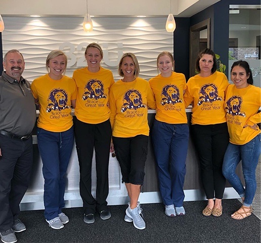 Dental team members wearing matching shirts