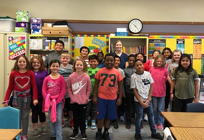 Kids and dental team members smiling together