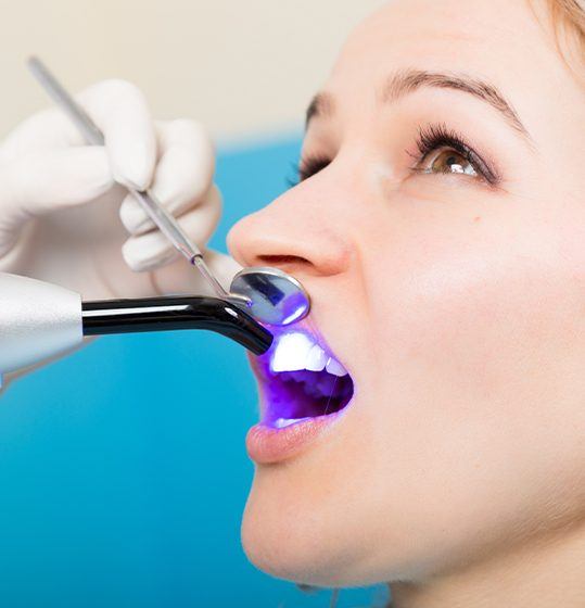 Woman receiving dental bonding treatment