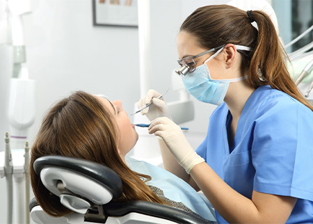 Woman getting dental cleaning in Denison