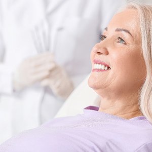 woman smiling while sitting in dental chair 