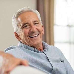 man smiling while sitting on couch