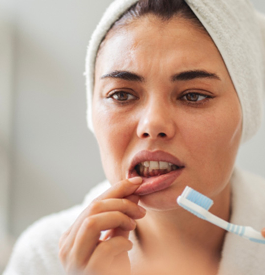 Patient looking concerned at their gums
