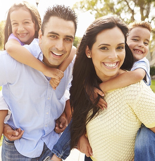 Family sharing beautiful healthy smiles