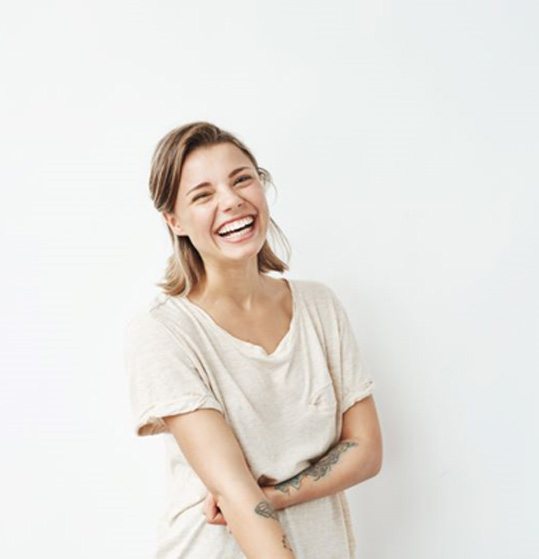 Portrait of smiling woman against neutral background