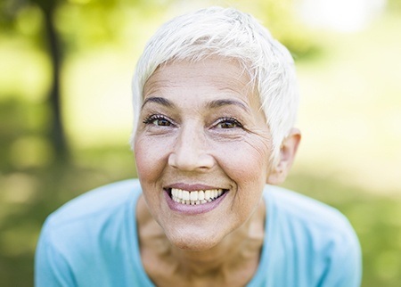 Woman sharing smile after dental implant placement