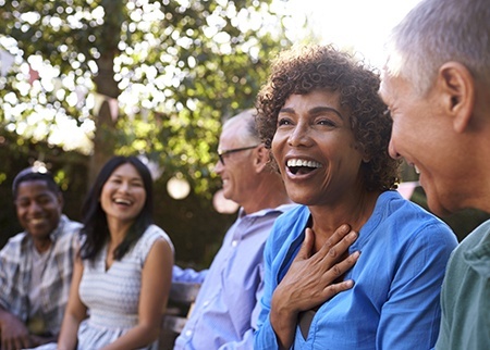 Group of friends laughing together outdoors