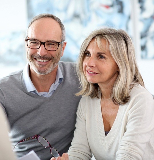 Older man and woman discussing dental insurance coverage