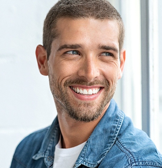 man smiling after Invisalign treatment