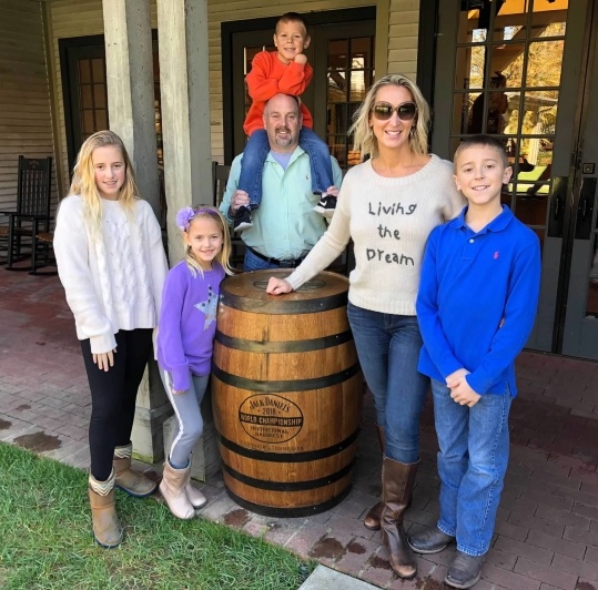 Dr. Bygness and his family smiling together outdoors