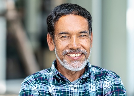 Man sharing healthy smile after replacing missing teeth