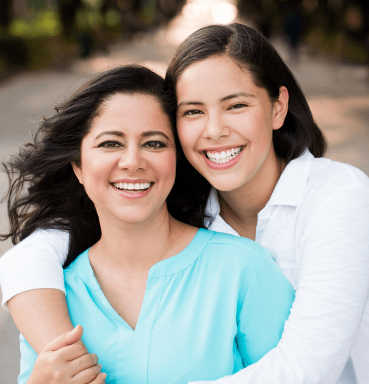 Teen girl with fixed retainer smiling with her mother