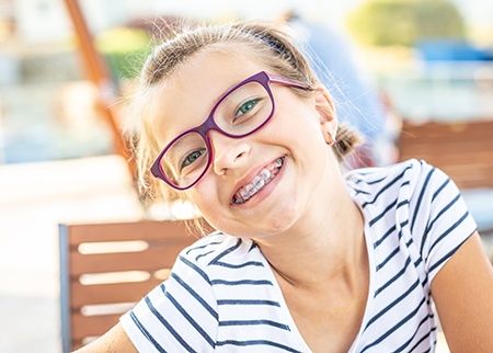 Girl with braces smiling outside