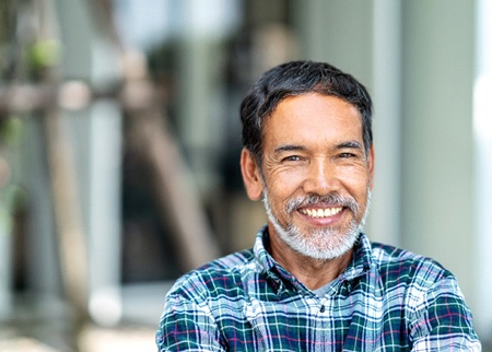 Man smiles after root canal therapy in Denison