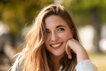 Young woman with flawless smile thanks to cosmetic dentistry
