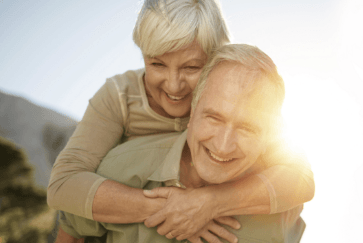 Older man and woman with healthy smiles after periodontal therapy