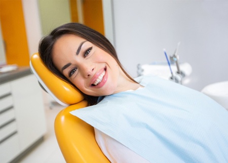 A smiling woman sitting in a dentist’s chair