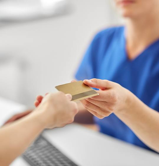 Handing over card to pay for dental treatment