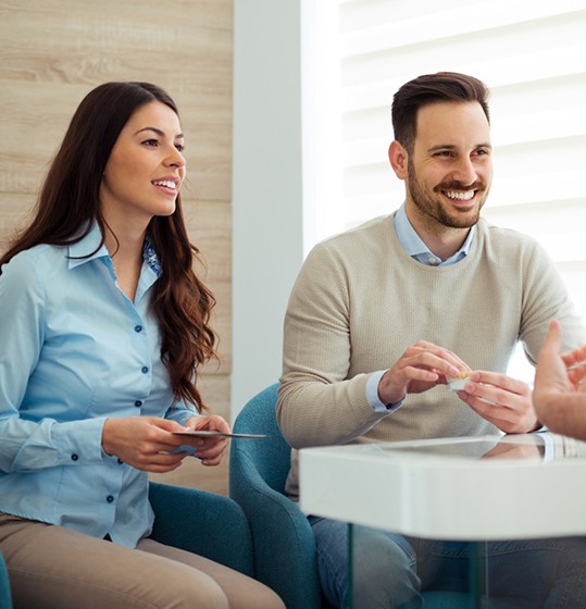 Dentist and patients having in-depth conversation