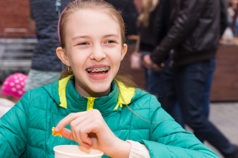 Schoolgirl eating food on her lunch break