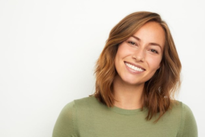 a woman smiling after receiving cosmetic dentistry