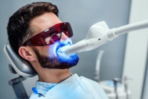 Man whitening his smile with a professional in-office dental visit